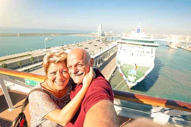 Game-loving couple playing photo scavenger hunt on their cruise ship holiday